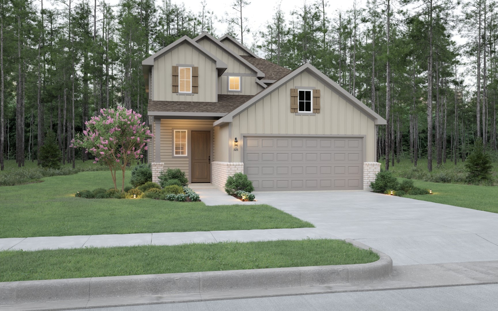 A modern two-story house with beige siding, a double garage, and a well-kept lawn. There are shrubs by the entrance, a blooming tree on the left, and tall pine trees in the background. The driveway is empty.