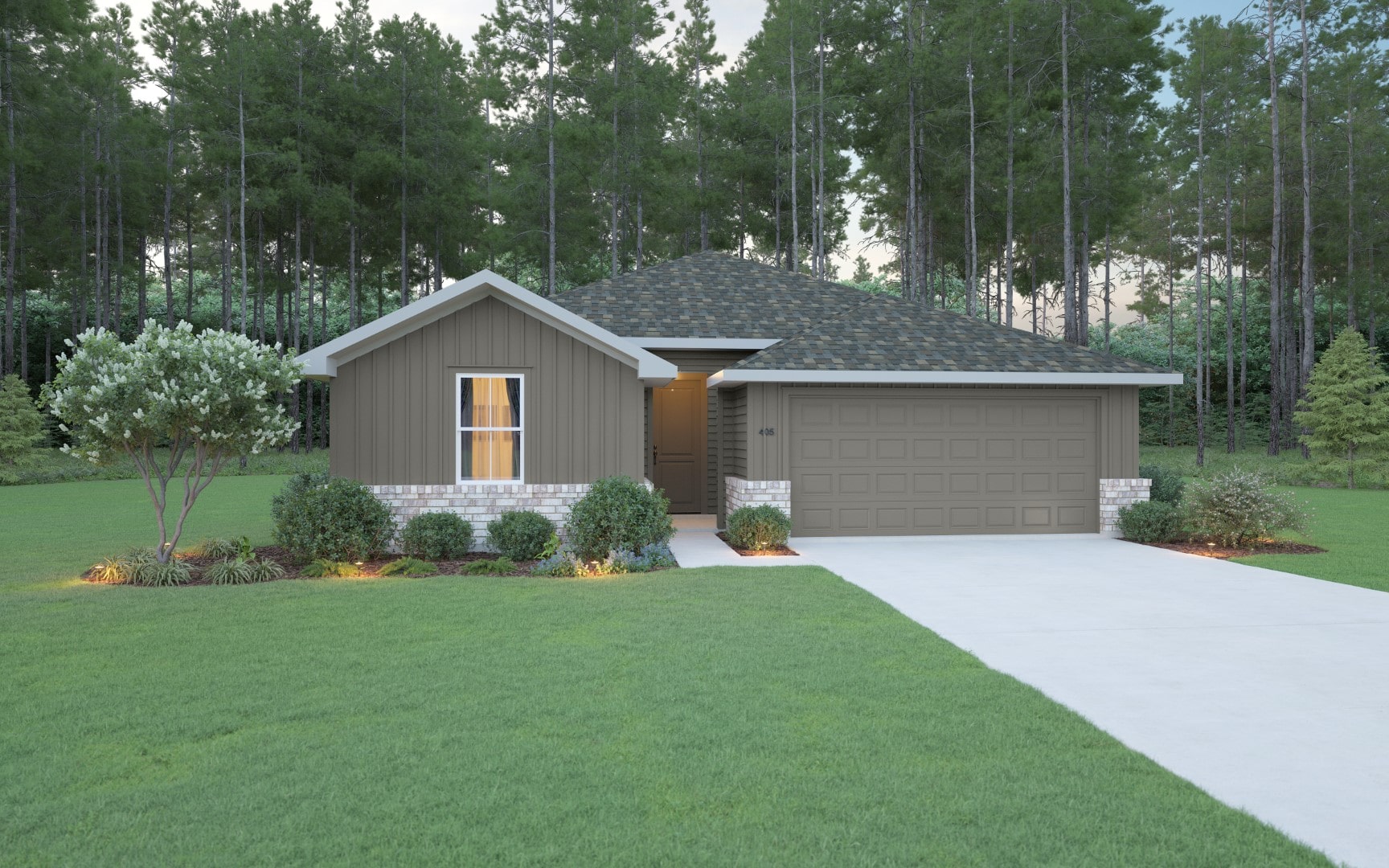 Single-story house with gray siding, stone accents, a two-car garage, front porch, neatly landscaped yard, and a concrete driveway. The house is surrounded by green grass and tall pine trees in the background.