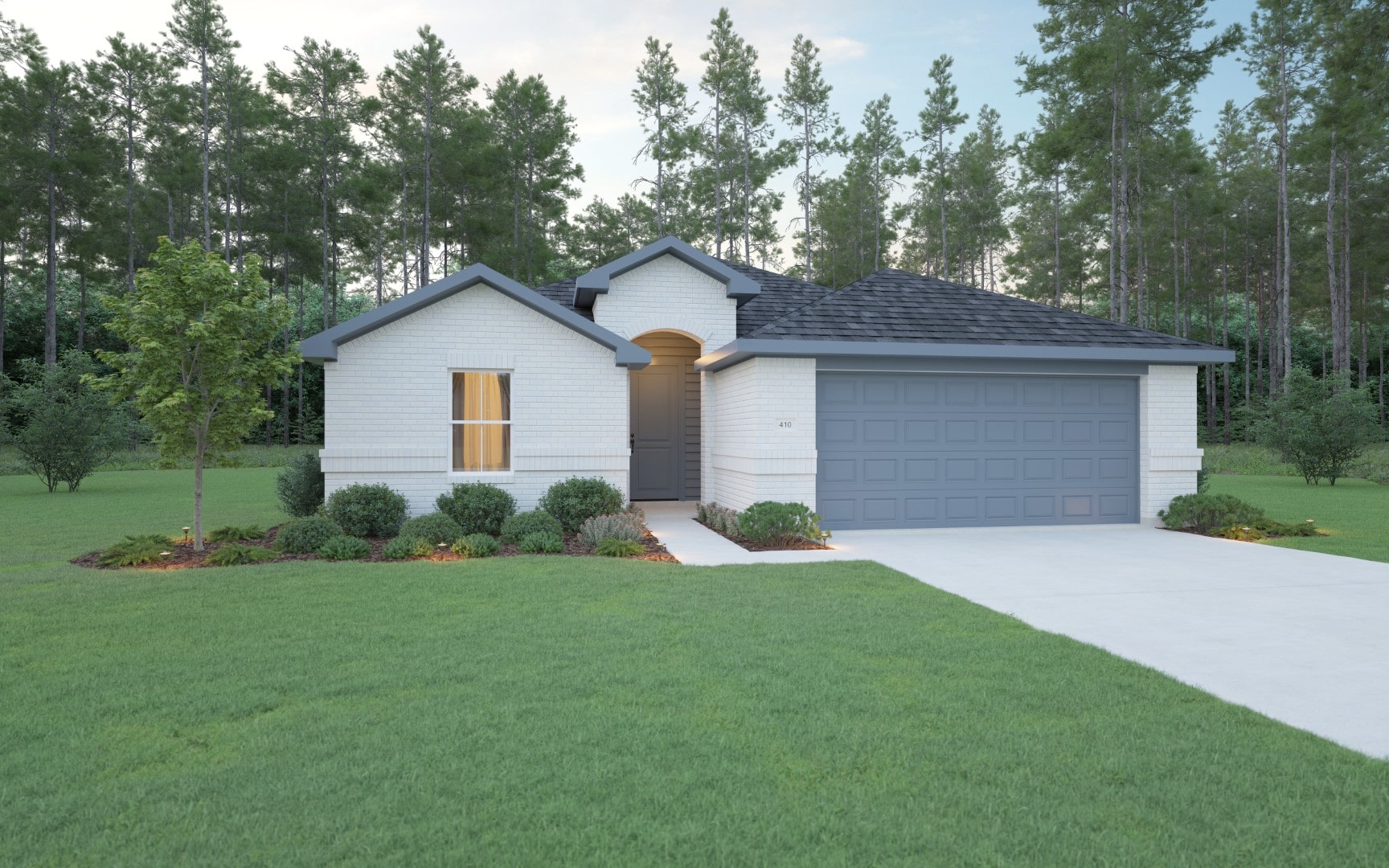 Single-story white brick house with a dark gray roof and matching garage door, surrounded by green lawn and small shrubs, set against a backdrop of tall pine trees.