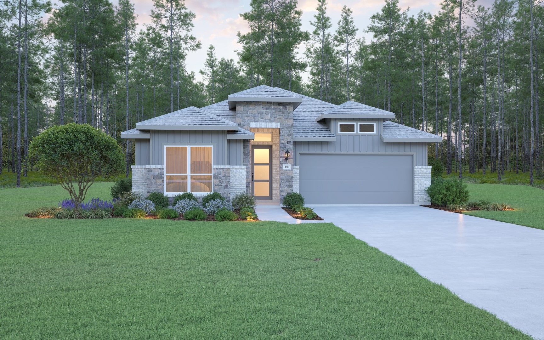 Single-story modern house with gray siding, stone accents, large windows, and a double garage, surrounded by a well-kept lawn and landscaping, with tall pine trees in the background.