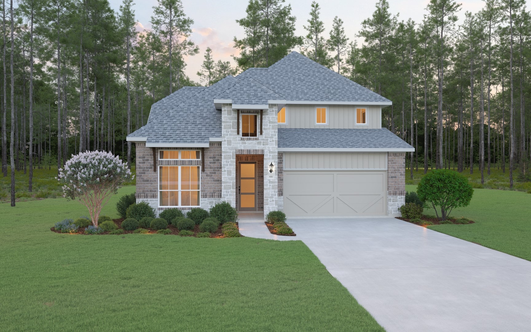 A modern two-story house with gray shingles, light brick and stone exterior, large windows, and a two-car garage, surrounded by manicured lawn, shrubs, and tall trees in the background.