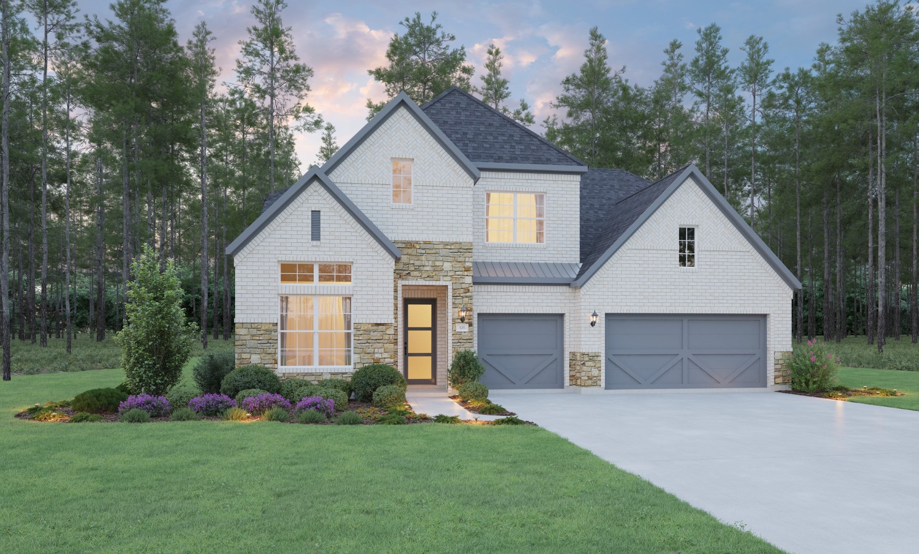 A modern two-story house with white brick and stone exterior, gray shingle roof, and three-car garage. The front yard is landscaped with bushes and flowers, surrounded by tall pine trees under a partly cloudy sky.