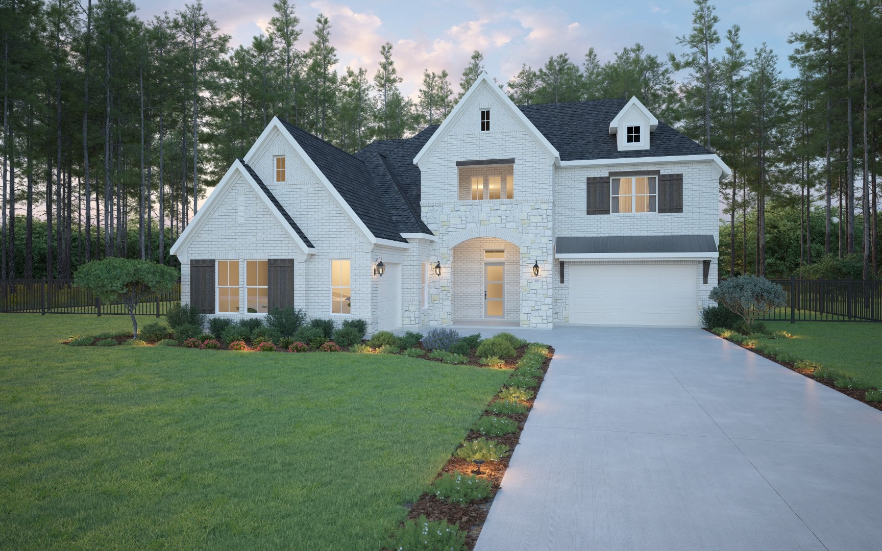 Modern two-story white brick house with dark shutters, arched stone entryway, and attached garage. The home is surrounded by a manicured lawn, garden beds, and tall trees in the background at dusk.